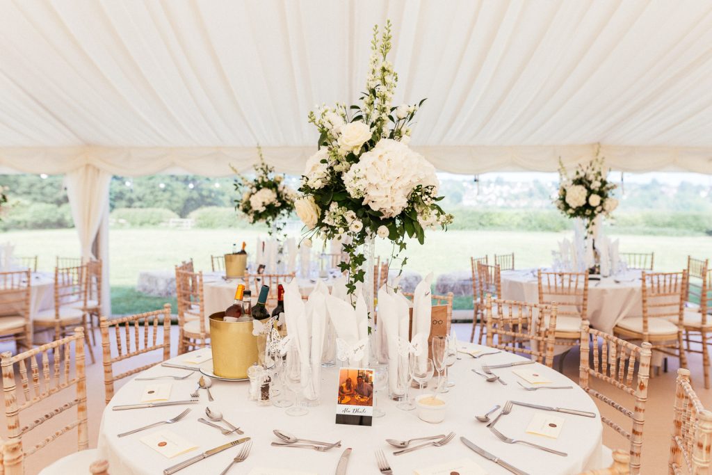 table flowers in marquee
